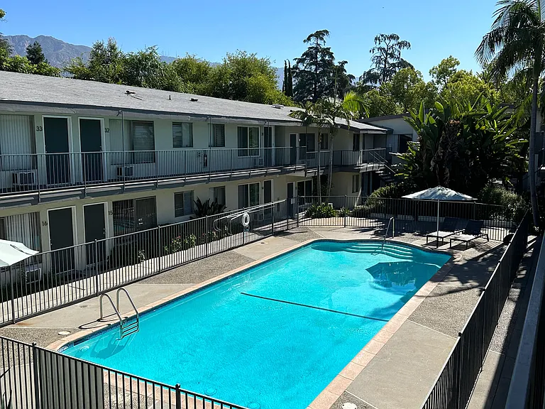 View of swimming pool and sun deck at Los Robles Apartments in Pasadena, California.
