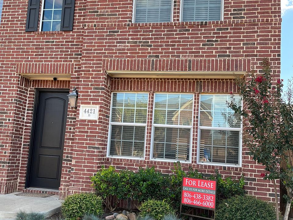 Beautiful garden home with large windows covered with wood blinds.