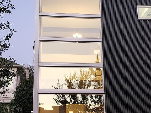 New metal siding and floor-to-ceiling windows.