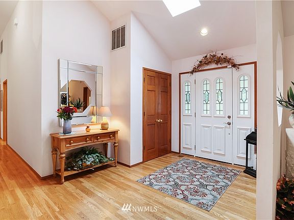 Entry with hard wood floors and skylight