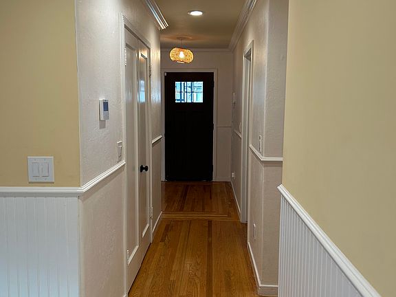 Hallway from front door, first bedroom is on the right, large closet on the left