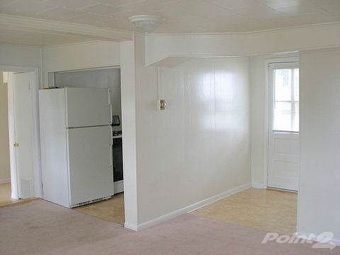 LIVING ROOM LOOKING TO FRONT DOOR AND KITCHEN