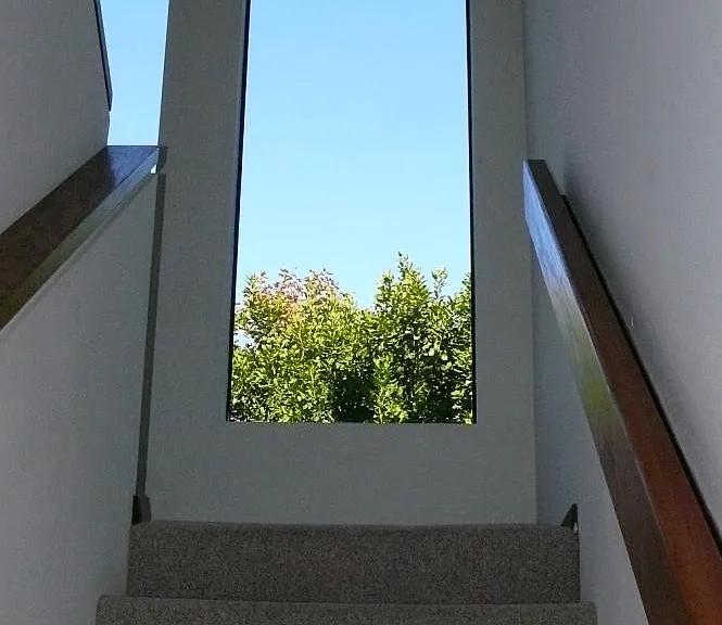 Natural light, high ceilings in stairwell leading to bedrooms.