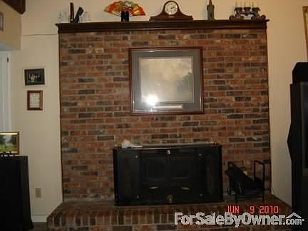 Large wood burning fireplace with insert in greatroom.