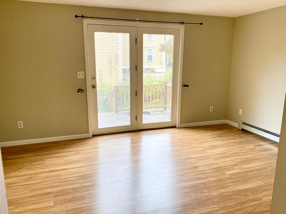 Empty living room, leading to the deck. The deck has been updated since since the picture.