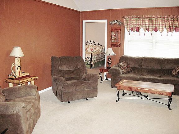 Large family room with vaulted ceiling and full windows for pretty back yard pool view.