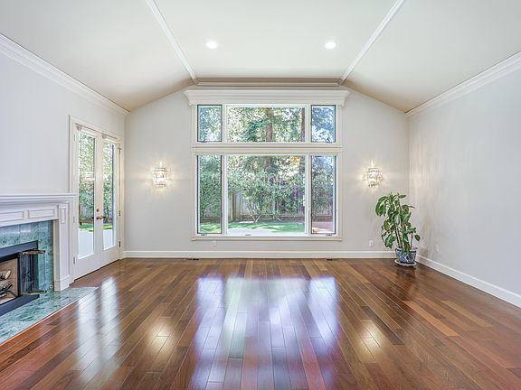 living room with soaring ceiling and a huge window