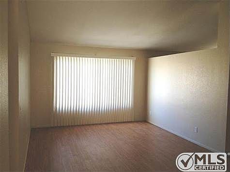 Living Room with large window, vaulted ceiling, plant shelf,