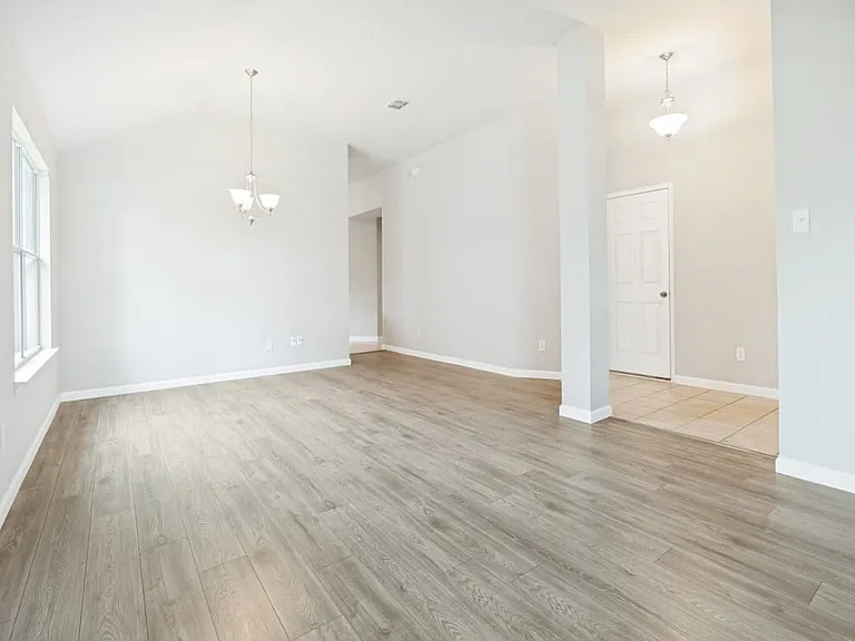 Open plan dining room with high ceilings and plenty of natural light.