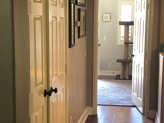 In a bedroom looking toward master bedroom. Laundry to the left