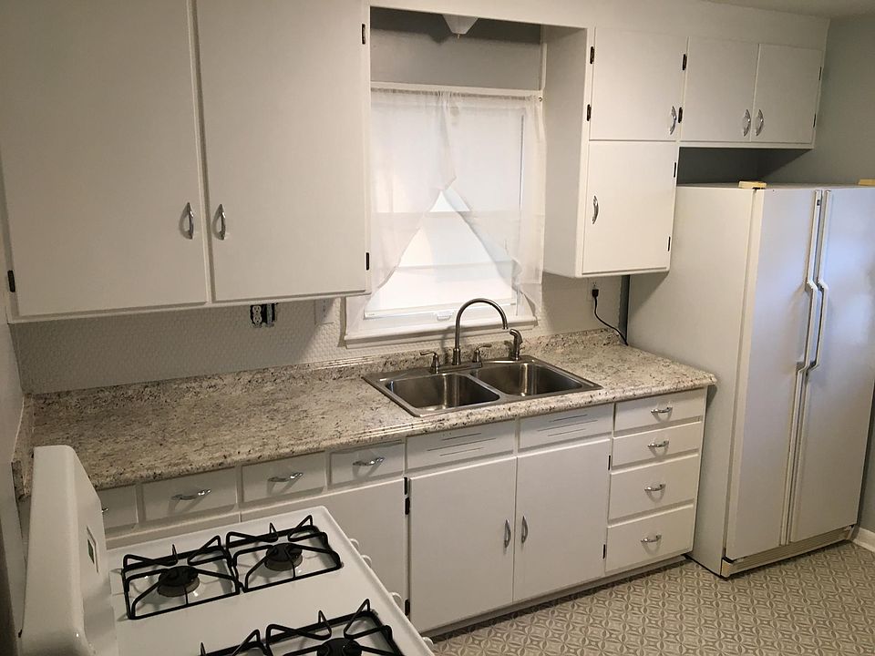 Love this kitchen new countertops, sink, faucet, lighting, and flooring. Fresh paint with up to date colors!
