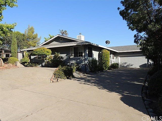 Split concrete driveway at front of home has plenty of room for your vehicles and toys