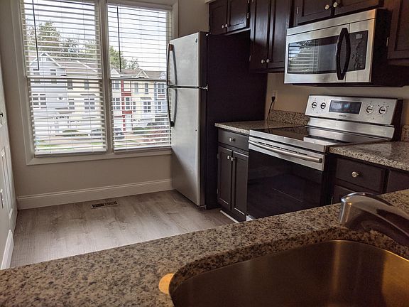 Kitchen with new vinyl plank floor, granite countertops and stainless appliances!