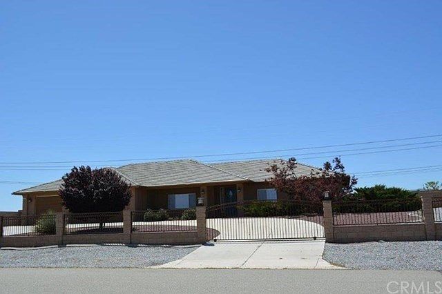 FRONT VIEW WITH CIRCLE DRIVE, BLOCK WALL, WROUGHT IRON ELECTRIC GATE, LANDSCAPING, AND TILE ROOF