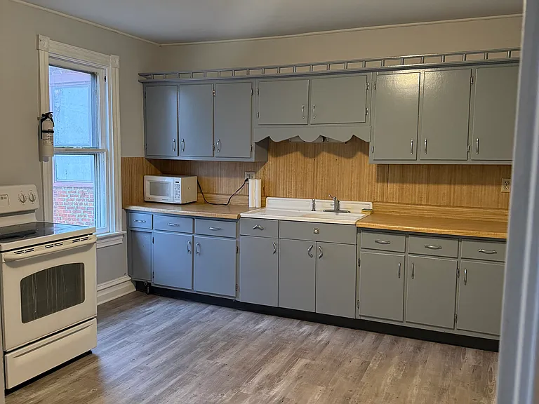 Kitchen, freshly painted cabinets, new flooring