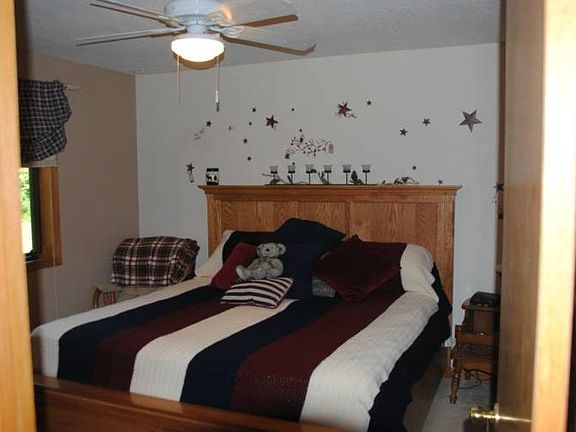 The master bedroom is neutral colored and neat.
