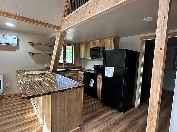 Kitchen with new appliances-Refrigerator, dishwasher, range, and microwave.