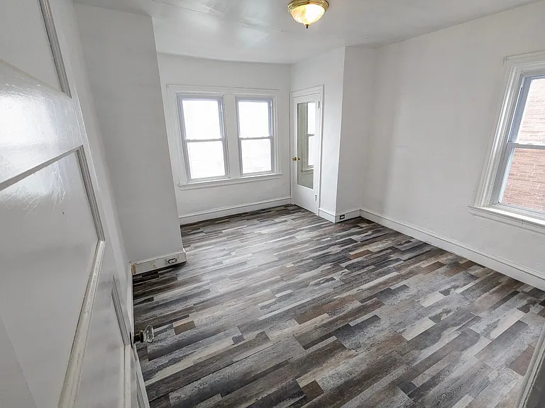 Bedroom 3. Newly renovated. 3 windows. 2 closets. New wood floor.