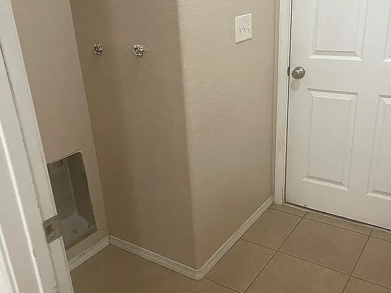 Laundry room off of kitchen with washer and drier hook ups