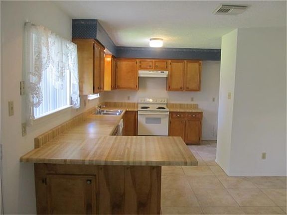 NICE OPEN KITCHEN WITH 16" TILE FLOORING LOTS OF COUNTER SPACE,ELECTRIC STOVE/OVEN DISHWASHER, UPDATED CABINETS