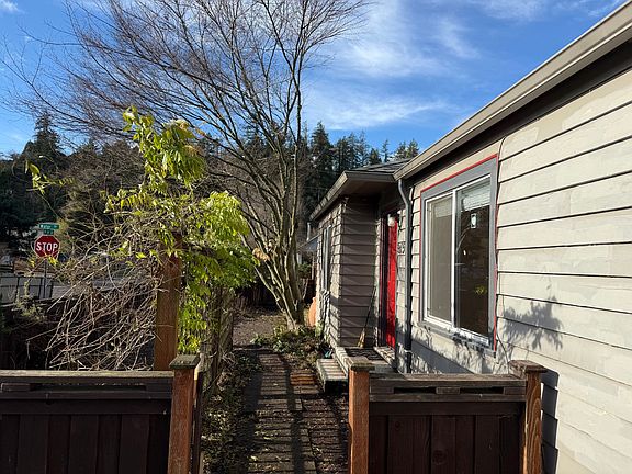 Front gate with paved walkway to front porch from driveway