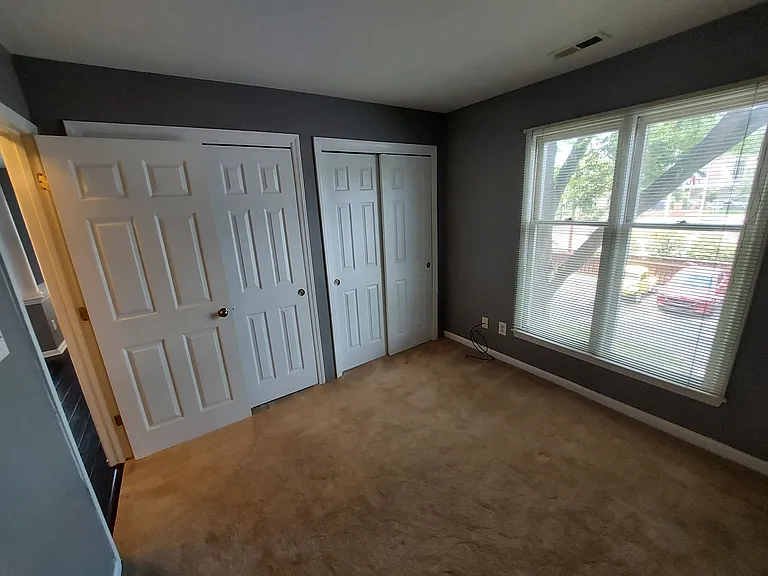 Second bedroom with large storage closets.
