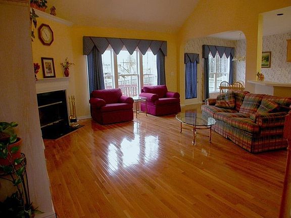 Note the gleaming hardwood floors, corner fireplace w/marble surround
