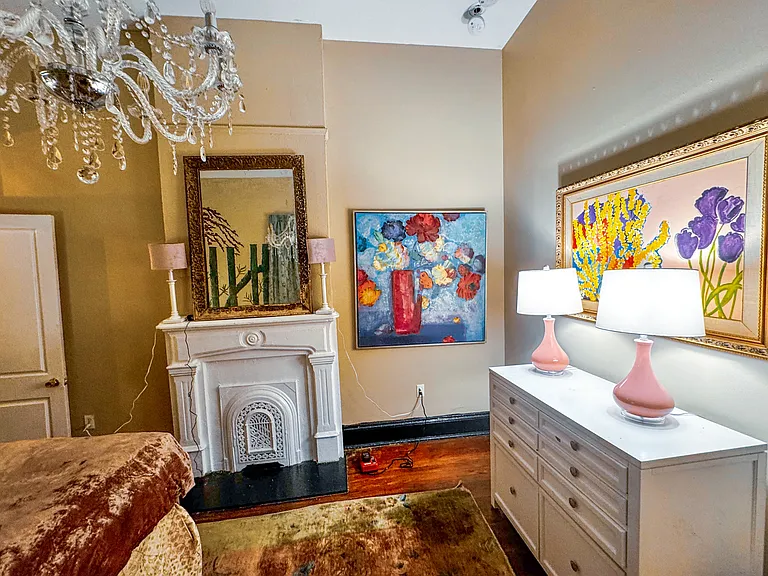 Fireplace, fun lamps and framed art complete the bedroom.