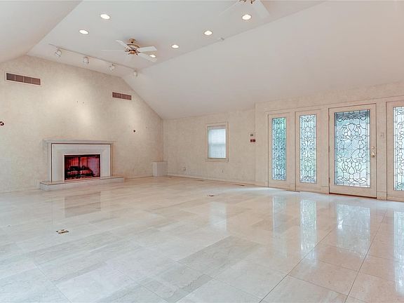 Another view of the 33 x 30 great room with gas fireplace. The door leads to a side walk in front of the home.