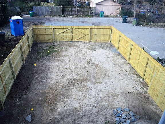Gravel parking beyond fence