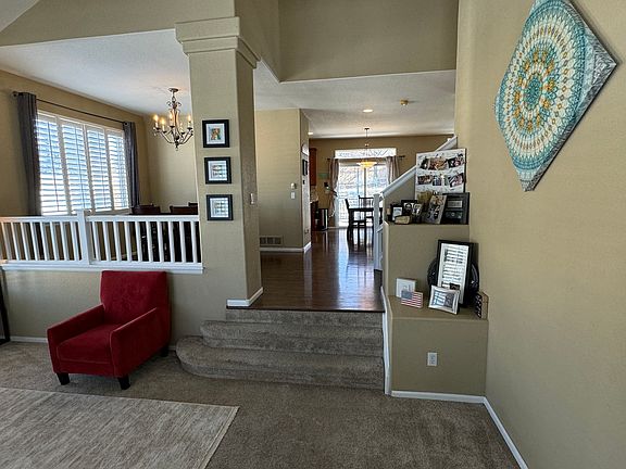 Entry looks into elevated kitchen and dining.