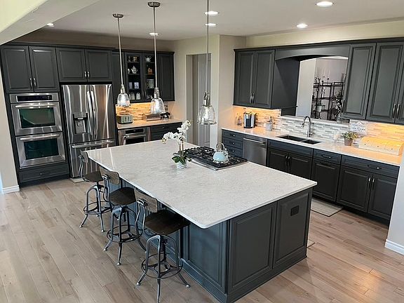 Large, modern open concept kitchen with quartz countertops