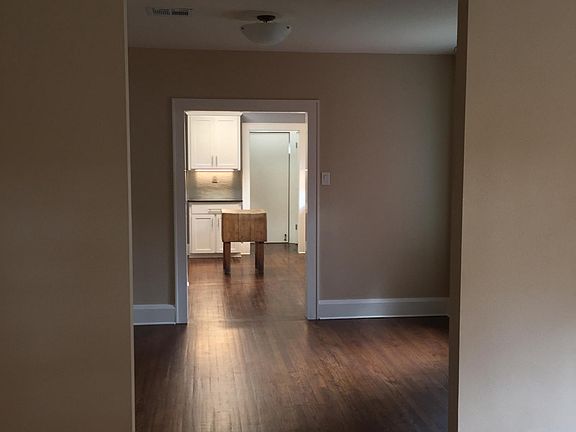 view of kitchen from living room through formal dining