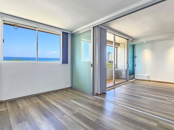 South facing bedroom with ocean view, sliding doors into the living room