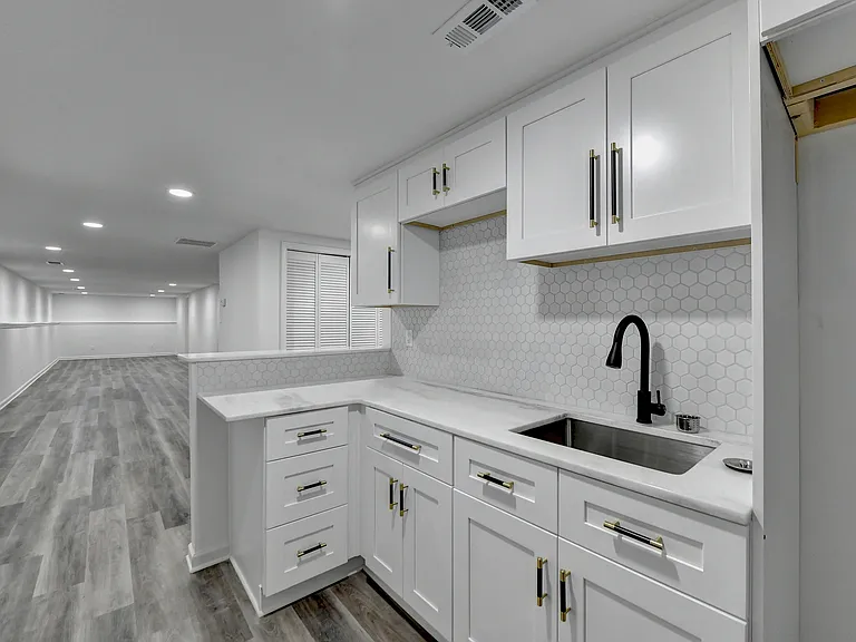 Kitchen with microwave owen, induction cooktop and refrigerator (not shown)