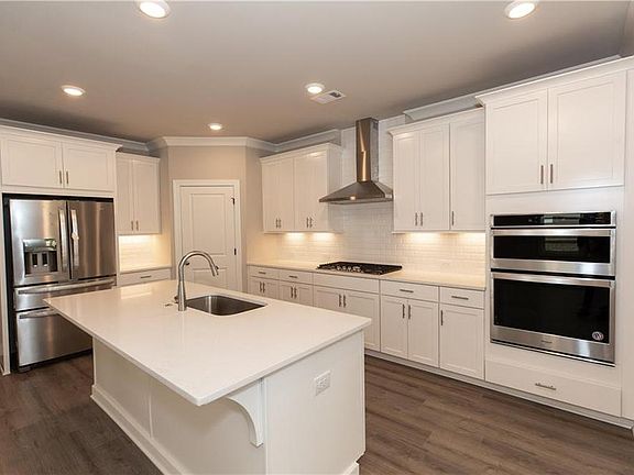 Beautifully designed kitchen with view to family room. Not actual home. Photos of previously built C