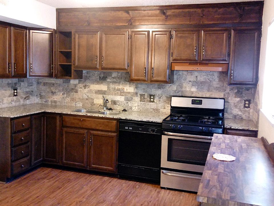 Kitchen with new granite counter tops, stainless steel sink,