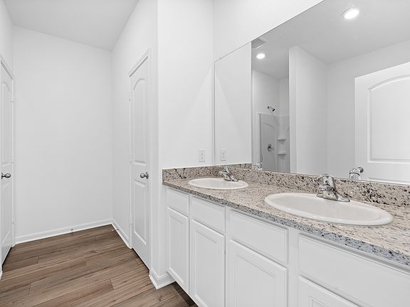 The master bathroom features a dual sink vanity.