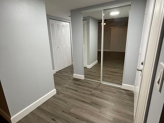 Well lit Foyer with mirror closet doors.