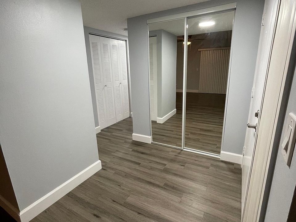 Well lit Foyer with mirror closet doors.