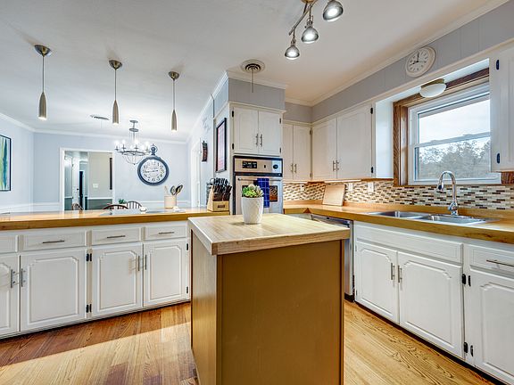 Kitchen with island and bowling lane countertops.