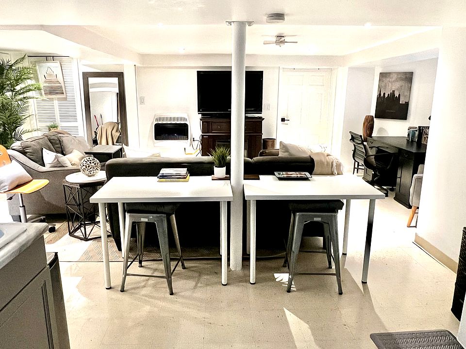 Unit B living room from kitchen, showing additional seating and dining tables