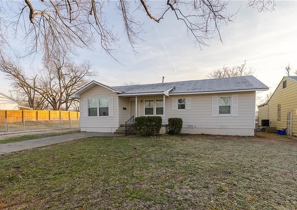 Front of Home - there is a two car attached garage on the side of this cute home!  Fresh paint and roof (3+ months). It doesn't look like it from the front, but this home is 1588 square feet, more or less!  Four beds, 2 1/2 baths, and two living areas!  N