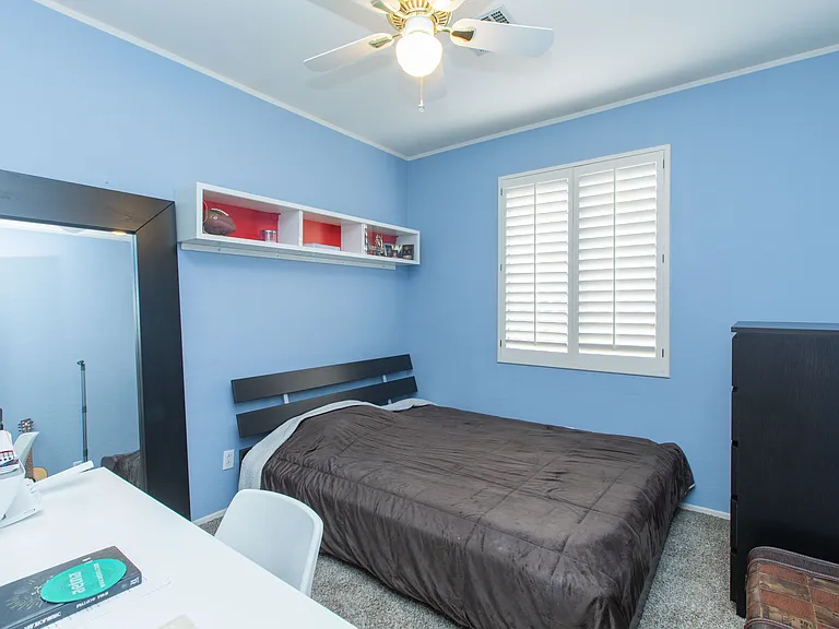 upstairs bedroom 1 featuring window wood shutters