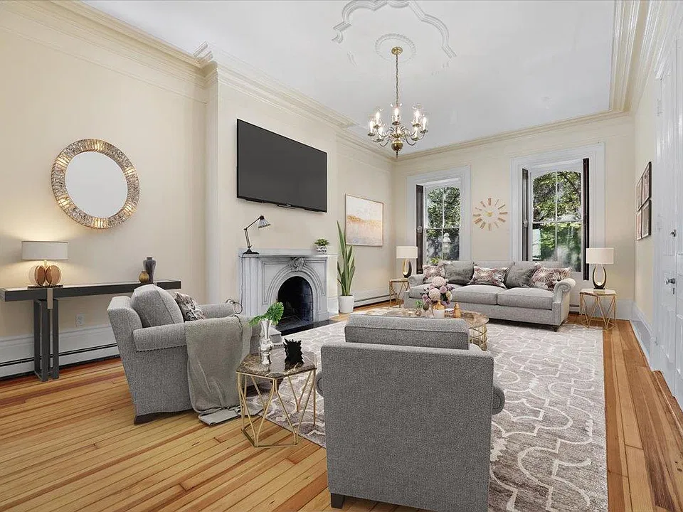 Living room virtually staged. TV goes on top of the fire place or via a media center. Not bracketed against the wall.