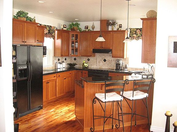 Kitchen - Cherry cabinets & floor with granite counter tops