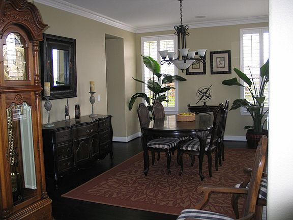 Dining Room with crown molding and plantation shutters