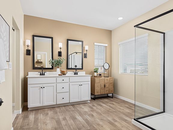 Primary bath with glass shower enclosure and vanity