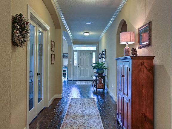 Lovely Entrance to Wood Floors, Crown Moulding, Fresh Paint and Arched Doorways!