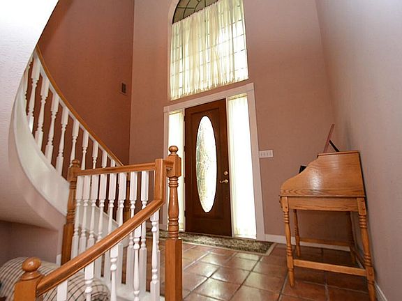 Elegant entry through a beveled glass front door, saltillo tile flooring opening to a split level ho
